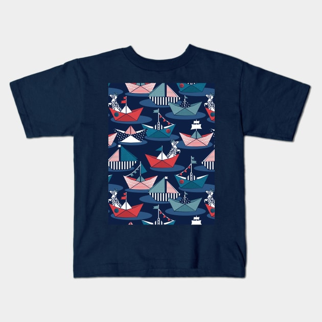 Origami dog day at the lake // pattern // navy blue background red teal and blue origami sail boats with cute Dalmatian Kids T-Shirt by SelmaCardoso